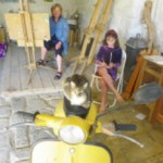 Julie Chrichinson, working on sketching the vespa during he painting holiday in Italy